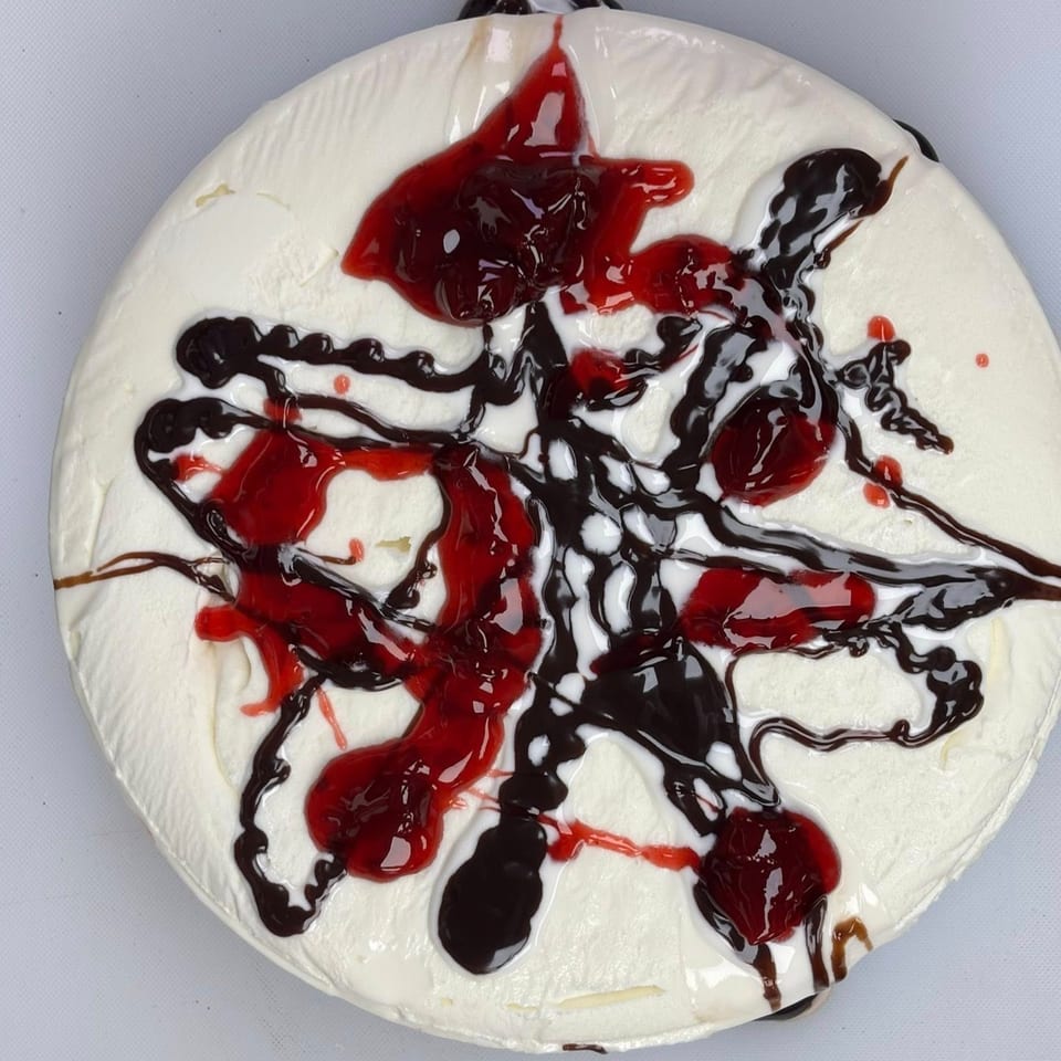 Overhead view of a Route 10 Drive-In ice cream cake with chocolate and cherry drizzle.