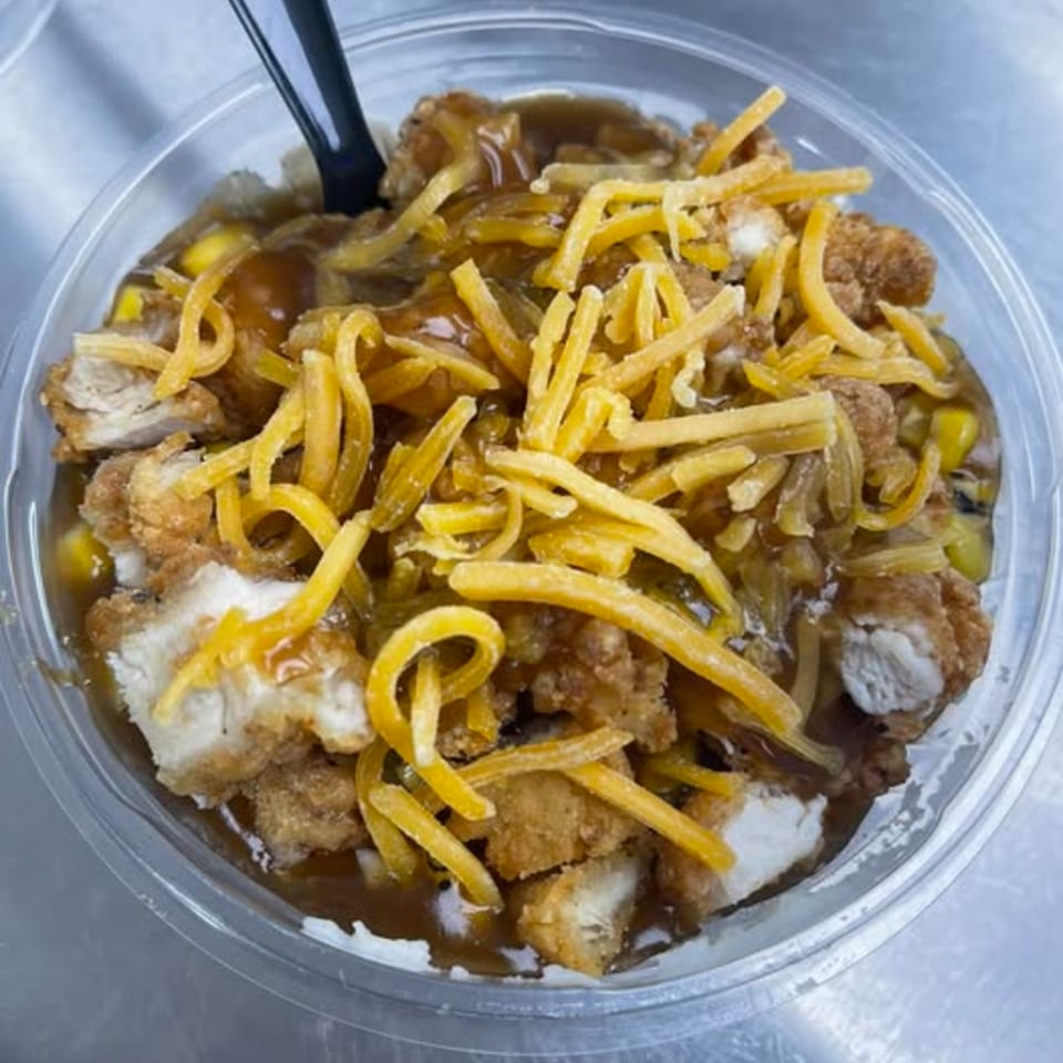 Route 10 Drive-In's fast-food bowl with fried chicken, gravy, corn, and shredded cheese.