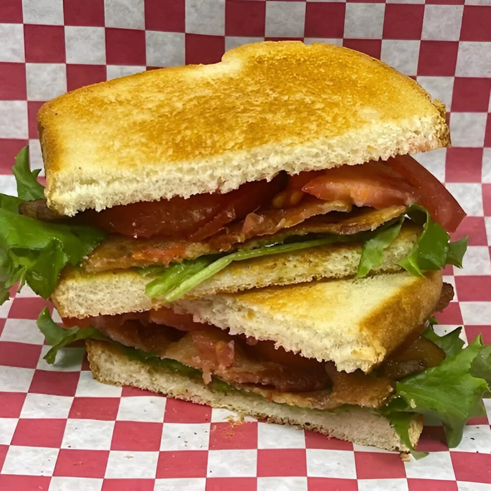 A Route 10 Drive-In BLT sandwich with bacon, lettuce, and tomato on toasted bread.